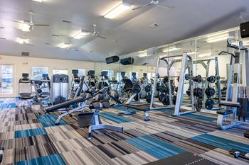 24-Hour fitness center with cardio and weights stations